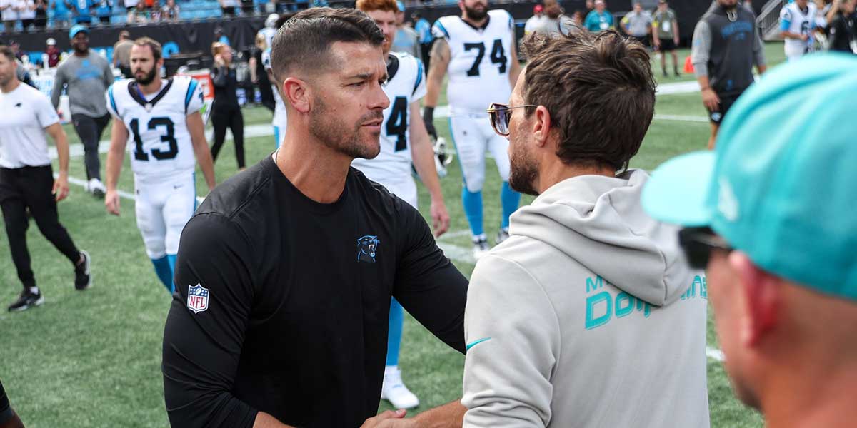 Carolina Panthers head coach Dave Canales shakes hands with Miami Dolphins head coach Mike McDaniel 2JJak3