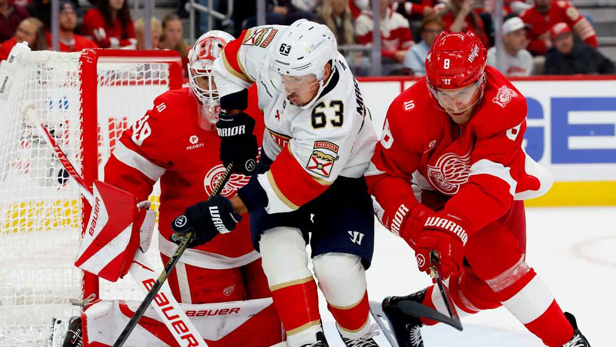 Panthers left wing Brad Marchand 63 and Red Wings defenseman Ben Chiarot 8 battle for the puck 8cF1mw