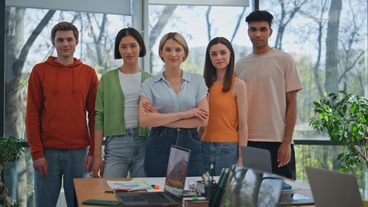 group portrait of happy corporate team in office smiling diverse startupers looking at SBI 350104208 GzmMRW